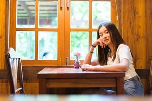 beautiful woman sitting in a chair in a cafe photo