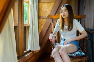 beautiful woman sitting on a chair in a cafe photo