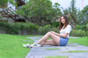 Beautiful women seats in the park photo