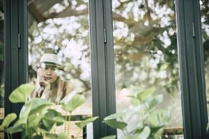 Beautiful girl sitting sad at the window in cafe photo