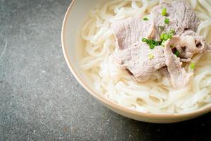 udon noodles with pork in clear soup photo