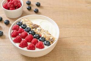 homemade yogurt bowl with raspberry, blueberry and granola photo