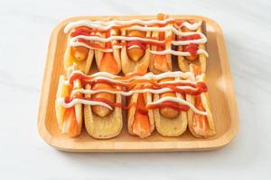 flat pancake roll with sausage and crab stick photo