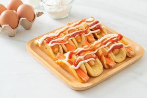flat pancake roll with sausage and crab stick photo