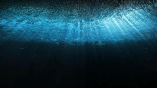 Deep blue underwater with sunlight rays shining through ocean surface photo