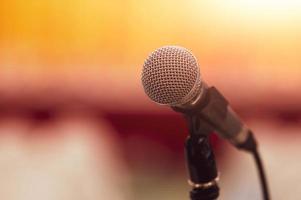 Closeup of microphone on abstract blurred background speech photo