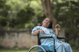 Anciana sentada en silla de ruedas con enfermedad de Alzheimer