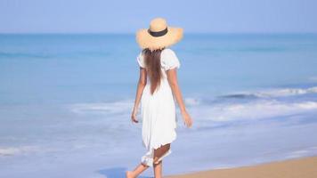 Asian woman enjoys beautiful ocean beach video