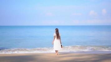 Asian woman enjoys beautiful ocean beach video