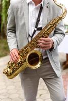 Saxophonist with saxophone photo