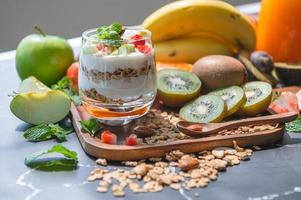 Closeup nutrition yogurt with many fruits on table photo