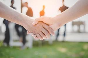 Handshake of two business people at outdoors photo