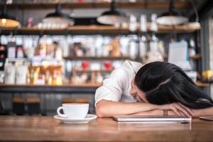 Asian woman is resting and sleeping in a coffee shop