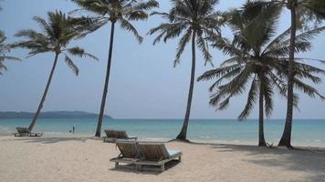 Hermosa playa de mar tropical con sombrillas y un cielo azul