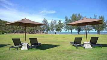 Beautiful tropical sea beach with umbrella chairs and a blue sky video