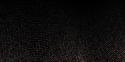 Abstract black background textured with golden halftone pattern.