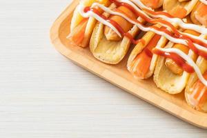 flat pancake roll with sausage and crab stick photo