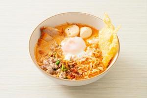 instant noodles with pork and meatballs in spicy soup