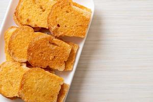 baked crispy bread with butter and sugar photo