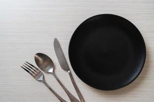 empty plate or dish with knife, fork and spoon photo