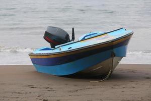 damaged boat stranded on the shore photo