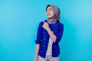 Good looking charismatic  woman with wearing hijab pointing photo