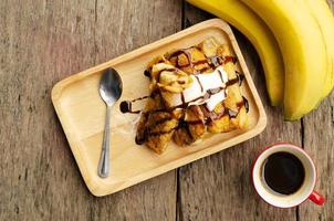 Banana French toast and coffee drinks on wood table backgrounds above photo