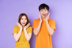 Asian couple portrait, isolated on purple background photo