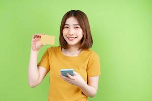 Young asian girl  posing on green background photo