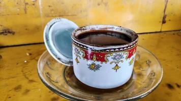 Black coffee is brewed in small glass cups, ready to drink. photo