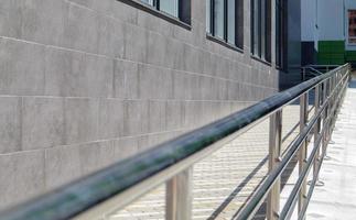 A ramp with stainless steel handrails for wheelchairs photo