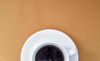 Black coffee in a white coffee cup on a gentle background. photo