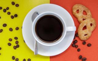 Black coffee in a white coffee cup on a bright background. photo