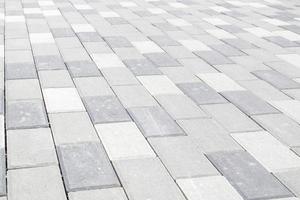 Concrete or paved newly laid gray paving slabs or stones for floors photo