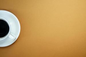 Black coffee in a white coffee cup on a gentle background. photo