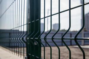 Steel lattice green fence with wire. Fencing. photo