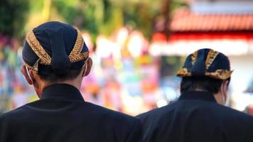 Men wearing traditional Javanese attire with blangkon photo