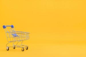 Shopping cart with yellow background photo