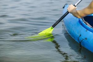 Man paddling in kayak on the lake photo