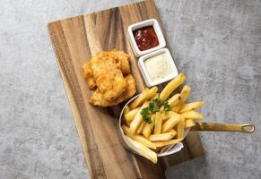 Traditional British Fish and Chips with french fries photo