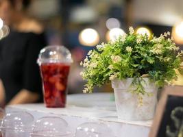 Strawberry and syrup in the plastic glass show on the shelf photo