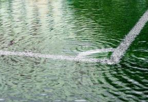 Flooding in artificial grass football field photo