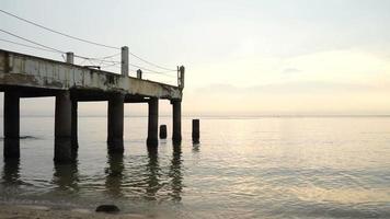 woestijnsteiger en zeegolven tijdens zonsondergang video