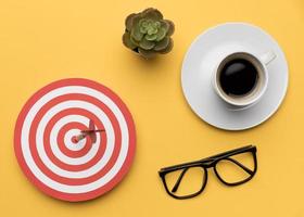 Dartboard, glasses and a cup of coffee