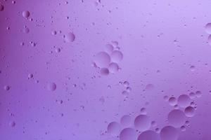 Water and oil, color abstract background based on pink and lilac color circles and ovals, macro abstraction, real photo. photo
