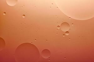 Water and oil, color abstract background based on orange color circles and ovals, macro abstraction, real photo. photo