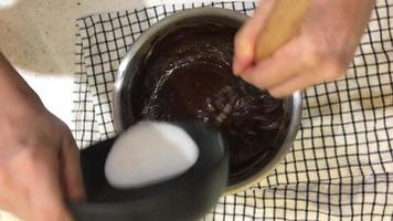 stir powder with chocolate and sugar for making bakery video