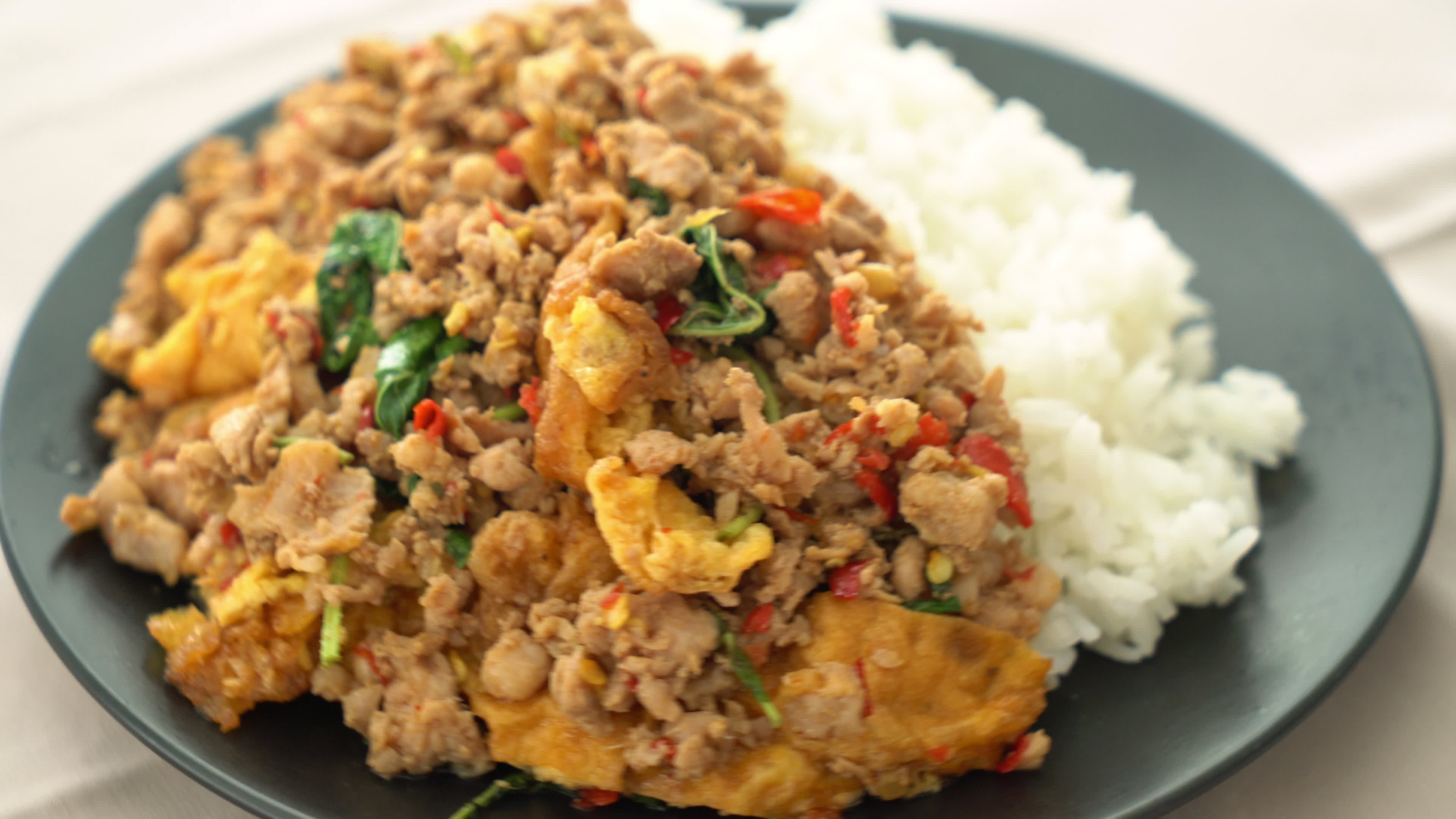 stirfried minced pork with fried egg and basil on rice 3473215 Stock