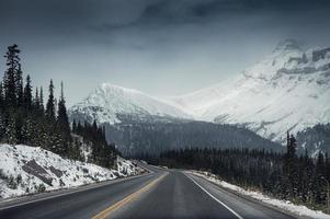 Scenic highway road trip with snow mountain in gloomy at Icefields Parkway photo