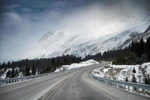 Scenic highway road trip with snow mountain in gloomy at Icefields Parkway photo